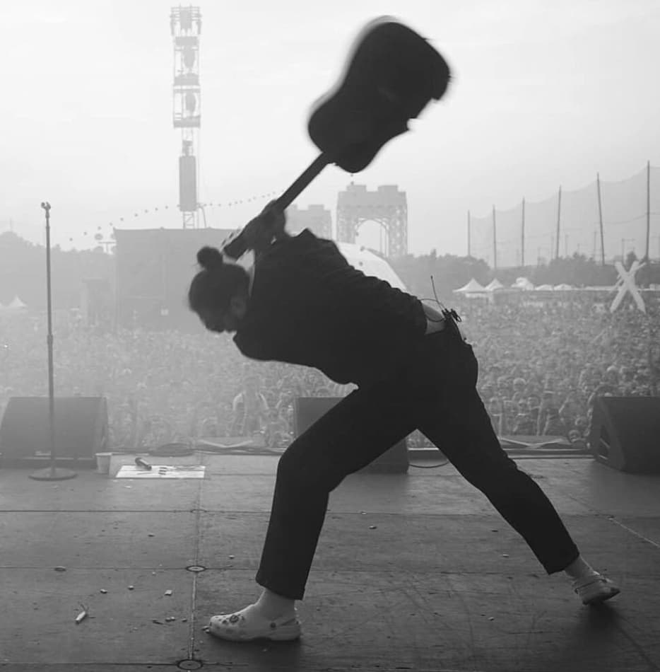 Post Malone smashes his guitar at a music festival, 2018.